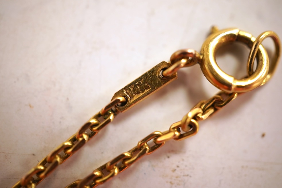 Two necklaces, comprising: a three-strand cultured pearl necklace, to a cabochon garnet and diamond clasp, length 34cm; and a paste and gilt metal pendant on a gold chain, chain length 44cm, stamped 14K, gross weight of